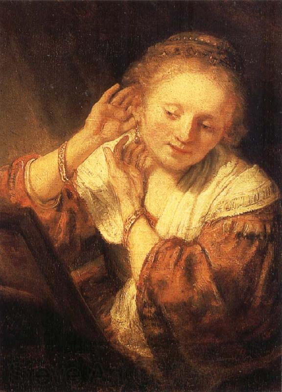 REMBRANDT Harmenszoon van Rijn Young Woman Trying on Earrings Germany oil painting art